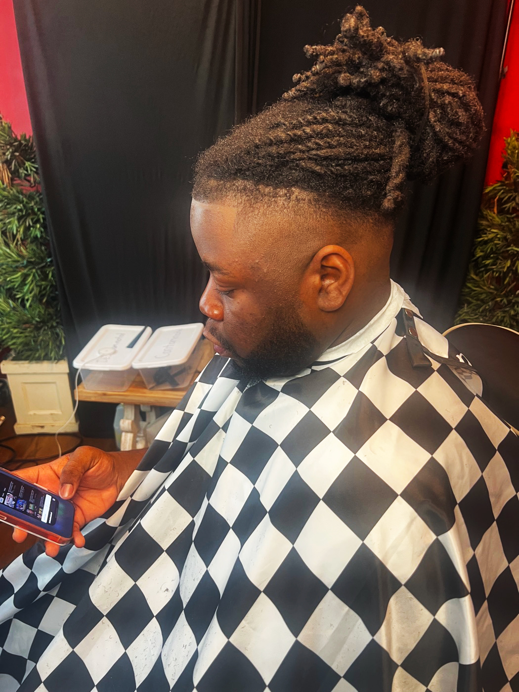 Marcus with a fresh fade and styled dreads at Kuts By Lee
