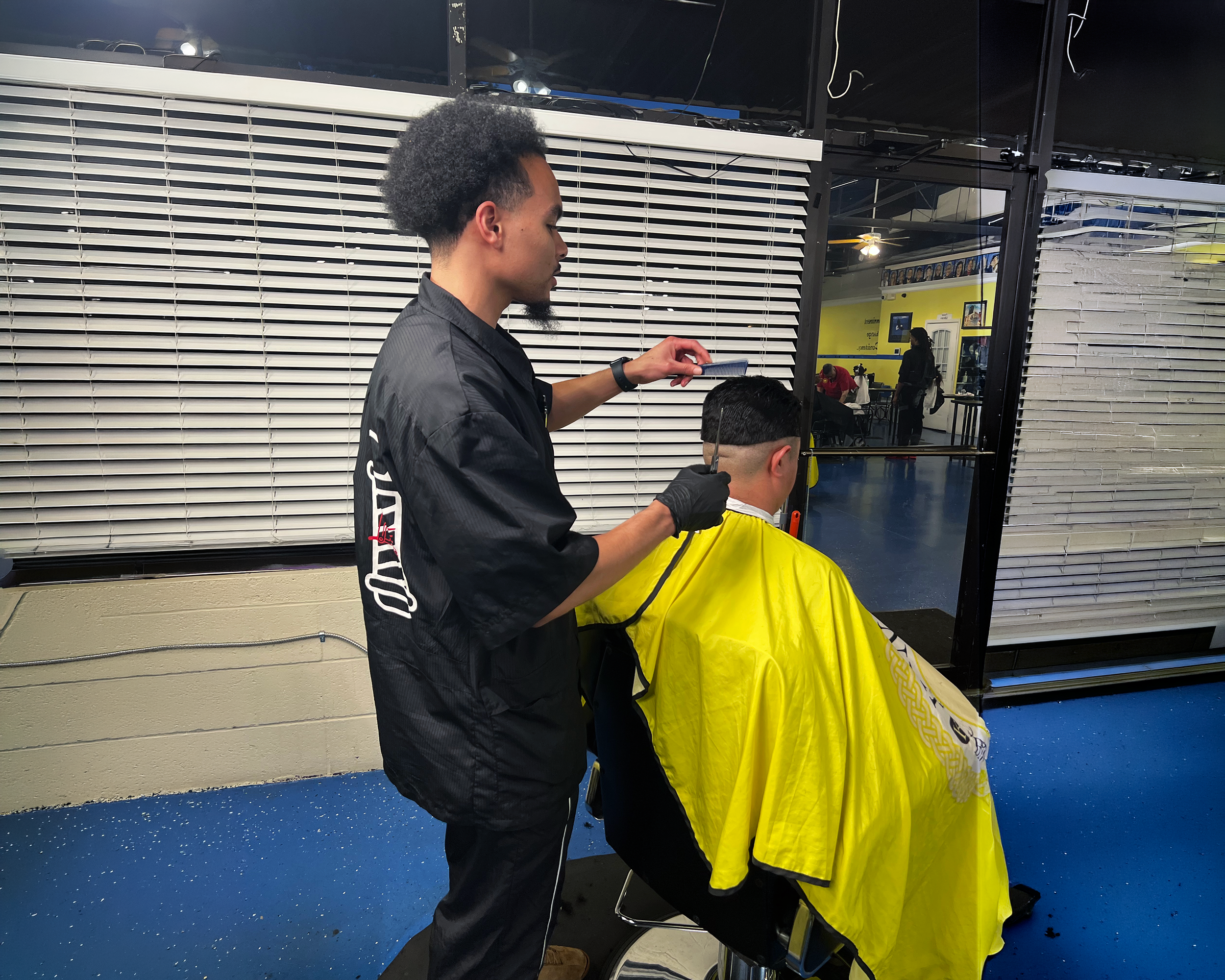 Lee cutting a client's hair at Kuts By Lee barbershop in Douglasville, GA